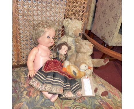 A steiff model of a duck together with two teddy bears and two dolls.