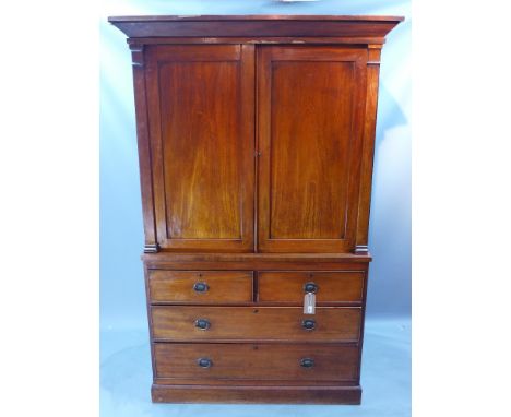 A Georgian mahogany linen press having two cupboard doors over two short and two long graduated drawers raised on a plinth ba