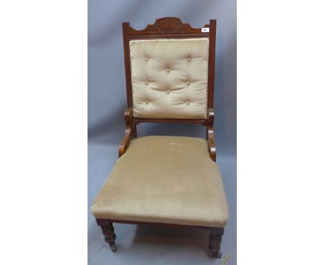 A Victorian mahogany button back salon chair with scallop shell cartouche raised on castors H 99cm  