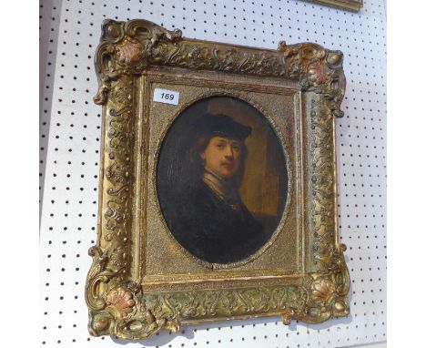 After Rembrandt a central oval oil on panel portrait of a gentleman unsigned in an ornately carved frame 28 x 22cm 