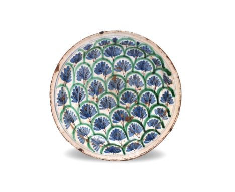 A SPANISH BLUE AND GREEN-PAINTED POTTERY CHARGER WITH PALMETTES Possibly Valencia or Manises, Post-Nasrid Spain, late 17th - 