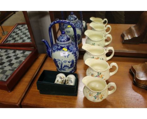 A set of three graduating elephant pottery jugs; together with a modern Chinese blue and white teapot and a garlic and a ging
