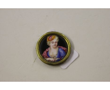 A circular gilt metal and enamel portrait plaque of a lady