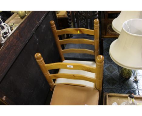 A set of four pine ladder back chairs