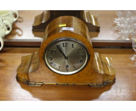 A walnut cased three hole mantel clock, key and pendulum on rostrum 