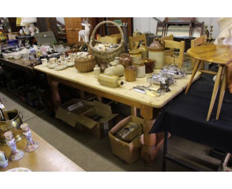 A large striped pine farmhouse kitchen table with a set of six ladder back chairs