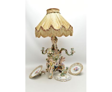 A LATE 19TH CENTURY MEISSEN FIGURAL AND FLORAL ENCRUSTED CENTREPIECE ADAPTED TO A TABLE LAMP, the later electric lamp fitting