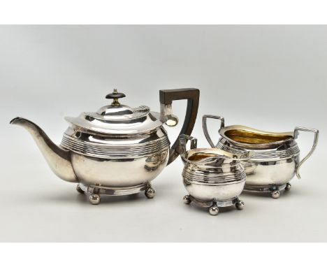 AN EDWARDIAN SILVER THREE PIECE SHAPED RECTANGULAR TEA SERVICE OF LATE GEORGIAN STYLE, horizontal reeded bands, the milk and 