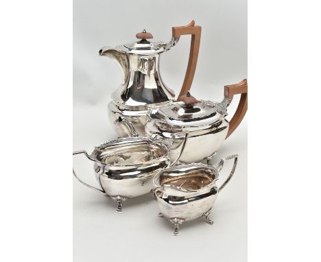 A FOUR PIECE SILVER TEA SERVICE OF SHAPED OVAL FORM, comprising tea pot, hot water jug, milk jug and twin handled sugar bowl,