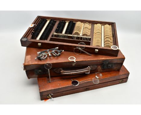 AN EARLY 20TH CENTURY MAHOGANY CASED OPTOMETRIST SET, the interior fitted with a selection of lenses and related equipment, w