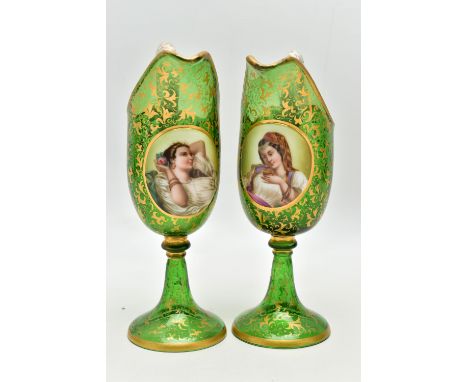 A PAIR OF 19TH CENTURY BOHEMIAN GREEN AND GILT GLASS PEDESTAL EWERS OF HELMET FORM, each with a white and gilt scrolled handl
