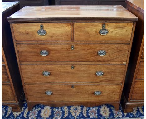 A 19th century mahogany chest of two short over three long drawers with brass handles, shaped apron and splayed bracket feet,