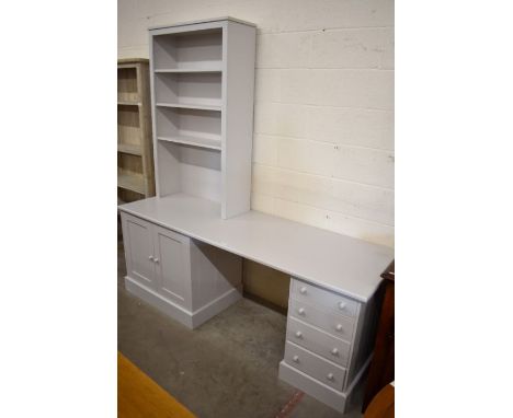 Dormy House - A large modular work station with adjustable three shelf bookcase on a desk with panelled cupboards and four dr