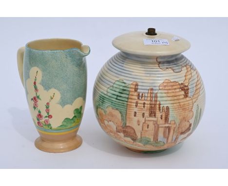 Art Deco pottery lamp base, painted with castle ruin in a landscape 19cm high, to/w a Clarice Cliff Honeyglaze jug, painted w