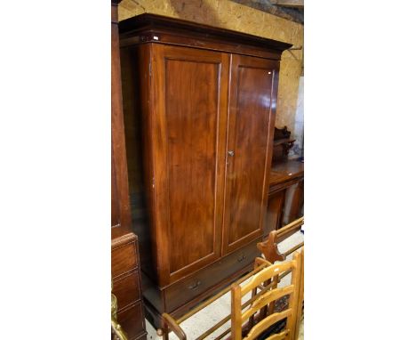 Late 19th century mahogany wardrobe with panelled doors enclosing hanging rail over a single drawer raised on bracket feet 12