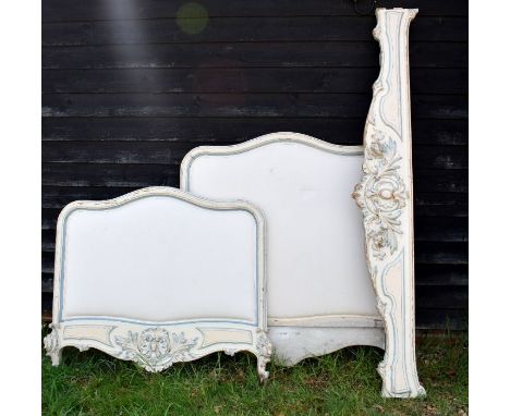 A Swedish cream and light painted single bed frame with foliate carved decoration and padded head and foot boards, 115 cm w c