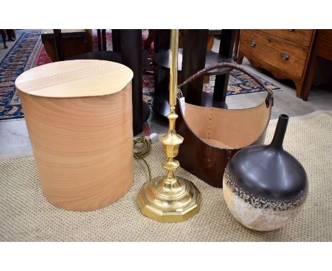 A brown leather storage basket with buckled strap to/with a small wooden linen basket, a brass standard lamp base and retro P