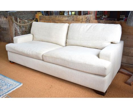 A contemporary oatmeal covered three seat sofa a/f