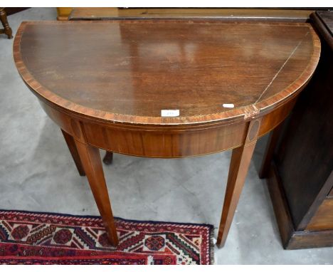 A 19th century mahogany crossbanded demi-lune card table with baize lined folding top and square tapering supports a/f, 92 cm