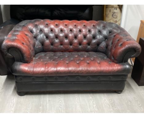 Dark Red leather &amp; metal studded chesterfield two seater sofa