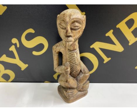 West African detailed wood carving of a pipe smoker, signed