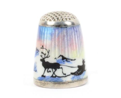 A Norwegian silver and enamel thimble with waffle top, depicting a Sami in a sled pulled by a reindeer, basse-taille ground, 