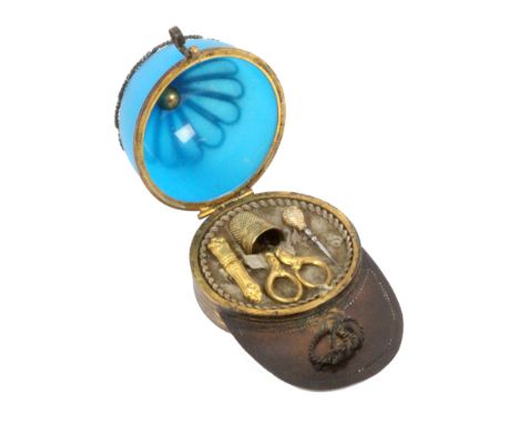 An unusual French etui for a child, circa 1880, in the form of a boys peaked cap in gilt brass and blue opaque glass, the pea