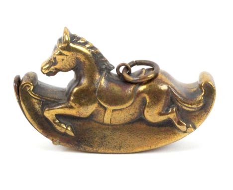 An unusual brass novelty vesta case in the form of a rocking horse, on ring suspension, 6cms.&nbsp; &nbsp; &nbsp; &nbsp; &nbs