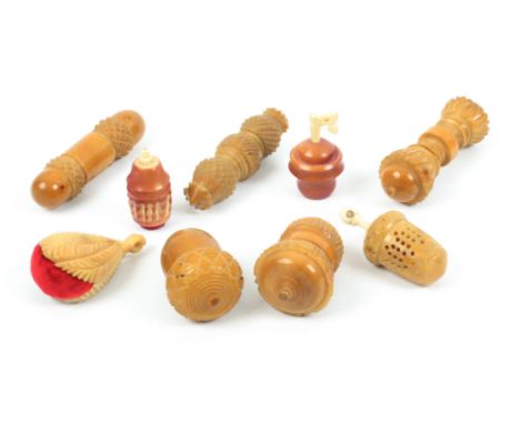 A mixed lot, sewing, all vegetable ivory, comprising four needle cases, one as a furled umbrella, largest 9.3cms, a leaf carv