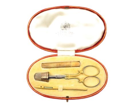 A red leather oval cased etui named for ‘Asprey and Co Ltd.’, gilt tooled decoration, silk lined lid interior with Royal Arms
