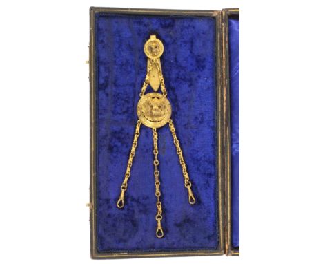 An unusual dog’s head gilt brass chatelaine, circa 1850, the clip with a circular pierced mount centred by a dog’s head with 