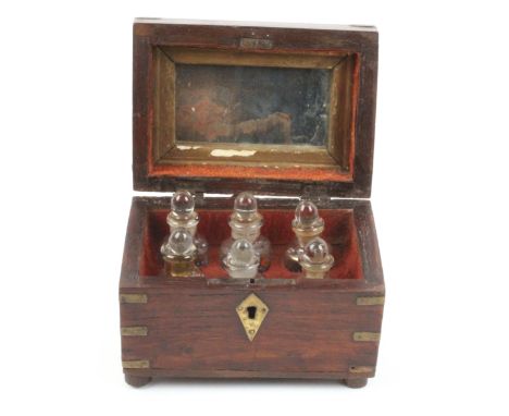 A brass bound and inlaid Indian teak scent casket fitted with a set of six painted scent bottles, with ball stoppers, 14.5 x 