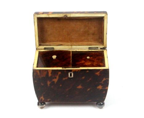 A tortoiseshell and silver inlaid tea caddy, circa 1810, in need of restoration, of sarcophagol form, raised on four Sheffiel