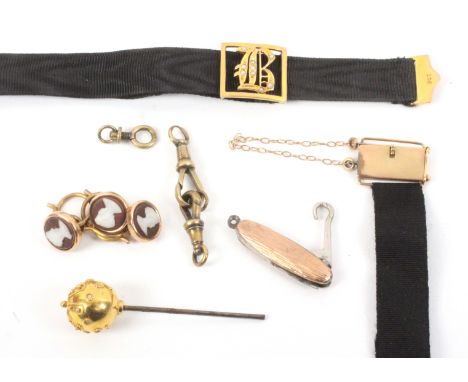 Gold and other items, comprising a miniature folding glove hook, the scales marked 9ct, a ribbon bracelet with 9ct gold mount