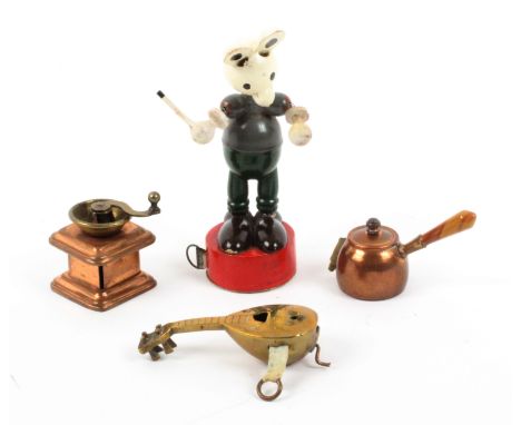 Four novelty tape measures, comprising a copper coffee grinder, tape lacking, a copper pan with agate handle, the complete pr