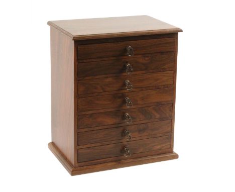 An English walnut collectors cabinet of seven drawers, with brass axe head handles by Richard Gravestock, cedar lined drawers