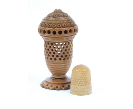 A vegetable ivory thimble case with corresponding thimble, the standing case with pierced decoration and fancy screw cover, t