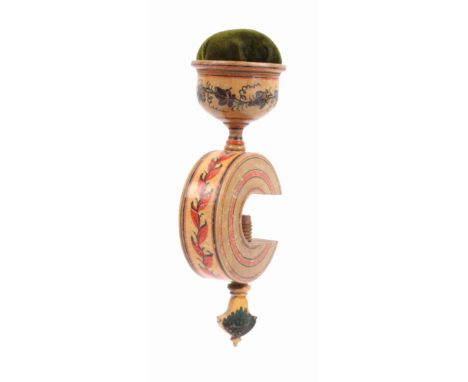 A whitewood paint decorated Tunbridge ware sewing clamp, the ‘C’ form frame with leaf painted decoration below a bowl form pi