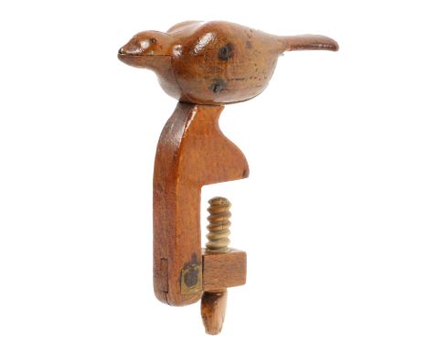 A primitive folk art fruitwood hemming bird clamp, the rectangular frame probably with old strengthening repair supporting a 