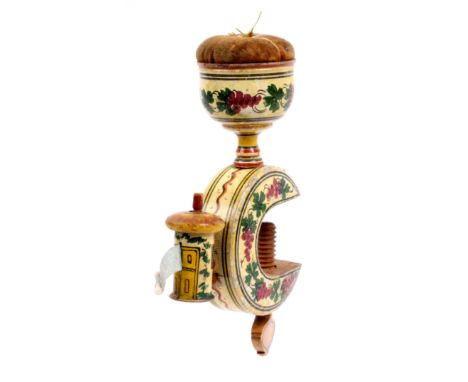 A whitewood paint decorated Tunbridge ware sewing clamp, the ‘C’ shaped frame brightly painted with fruiting vines on a cream
