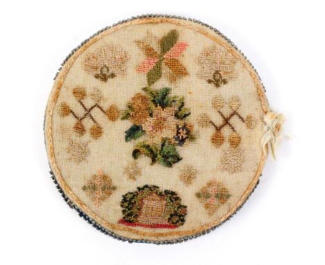 An early 18th Century sampler style circular needle book / pin disc, each side with spot sampler style petit point motifs inc