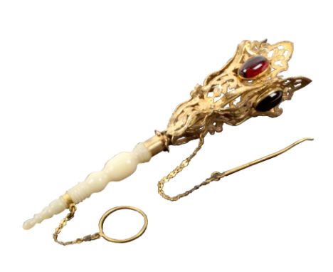 A posy holder, the turned tapering mother of pearl stem with ring and chain below a gilt metal pierced and leaf engraved trum