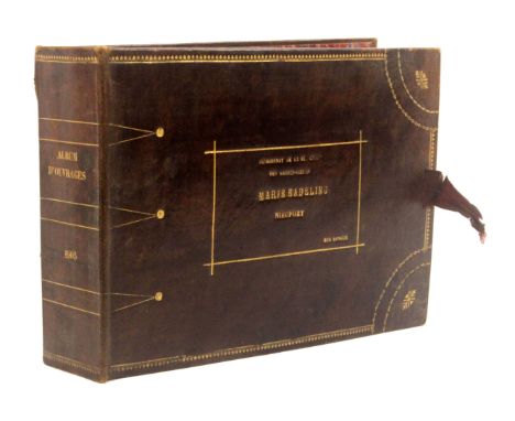A fine boarding school educational sample book, of needle work techniques and miniature clothing, the gilt tooled leather boo