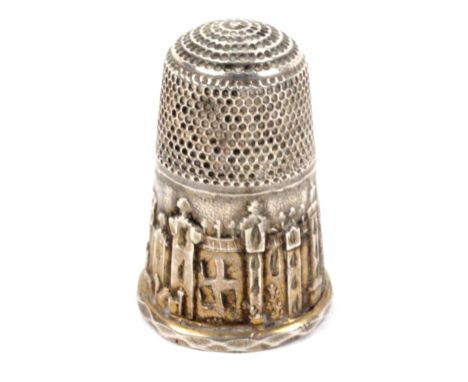 A good silver souvenir thimble, the frieze with an untitled view of Windsor Castle amid trees over a faceted rim, with a late