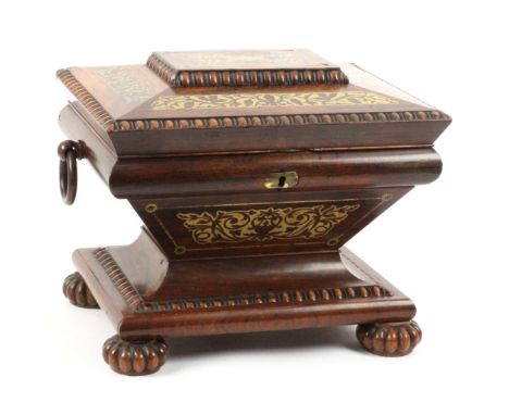 Am elaborate rosewood and cut brass inlaid sewing box of sarcophagol form, circa 1840, the rectangular base raised on knurled