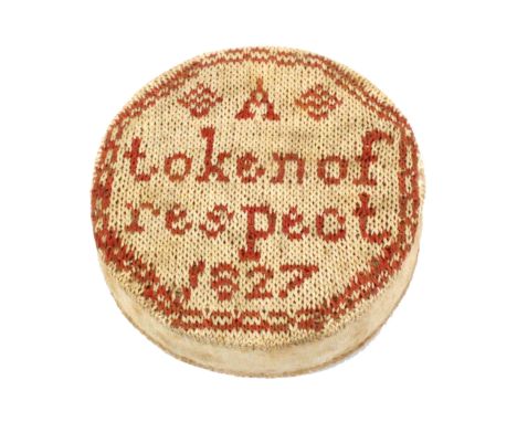 A good sampler style disc form pin cushion dated 1827, worked in brick red and cream, one side inscribed ‘A Token of respect 