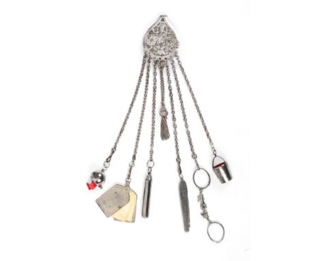 A steel chatelaine, the teardrop hook mount with scrolls and flowerheads to seven chains with ball form tape measure, the red
