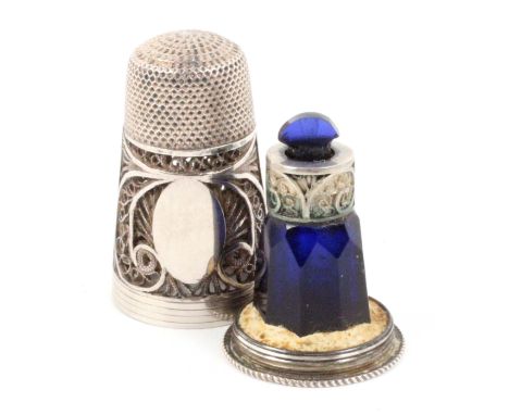 A good example of an English silver filigree thimble / scent bottle combination, the body in quill work with vacant cartouche