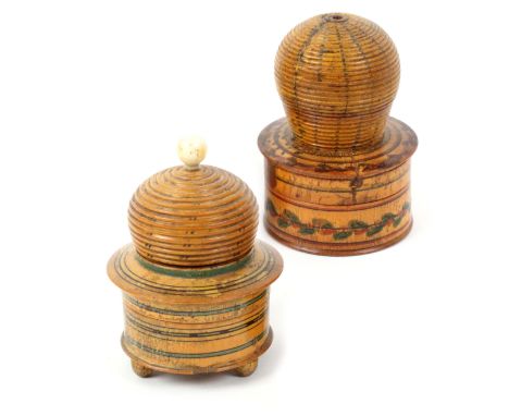 Two whitewood paint decorated Tunbridge ware bee skep pin cushions, one with circular box base raised on three bun feet, the 