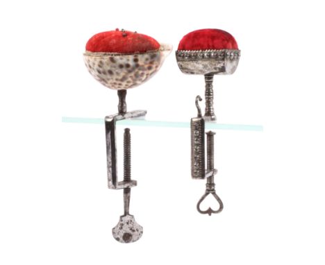 Two steel sewing clamps, comprising an embellished example with rectangular frame mounted with a hook below a trough form pin